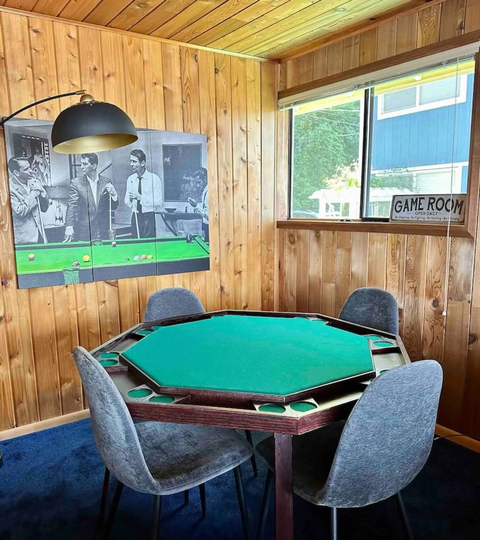 Game room with poker table and Rat Pack pool hall art